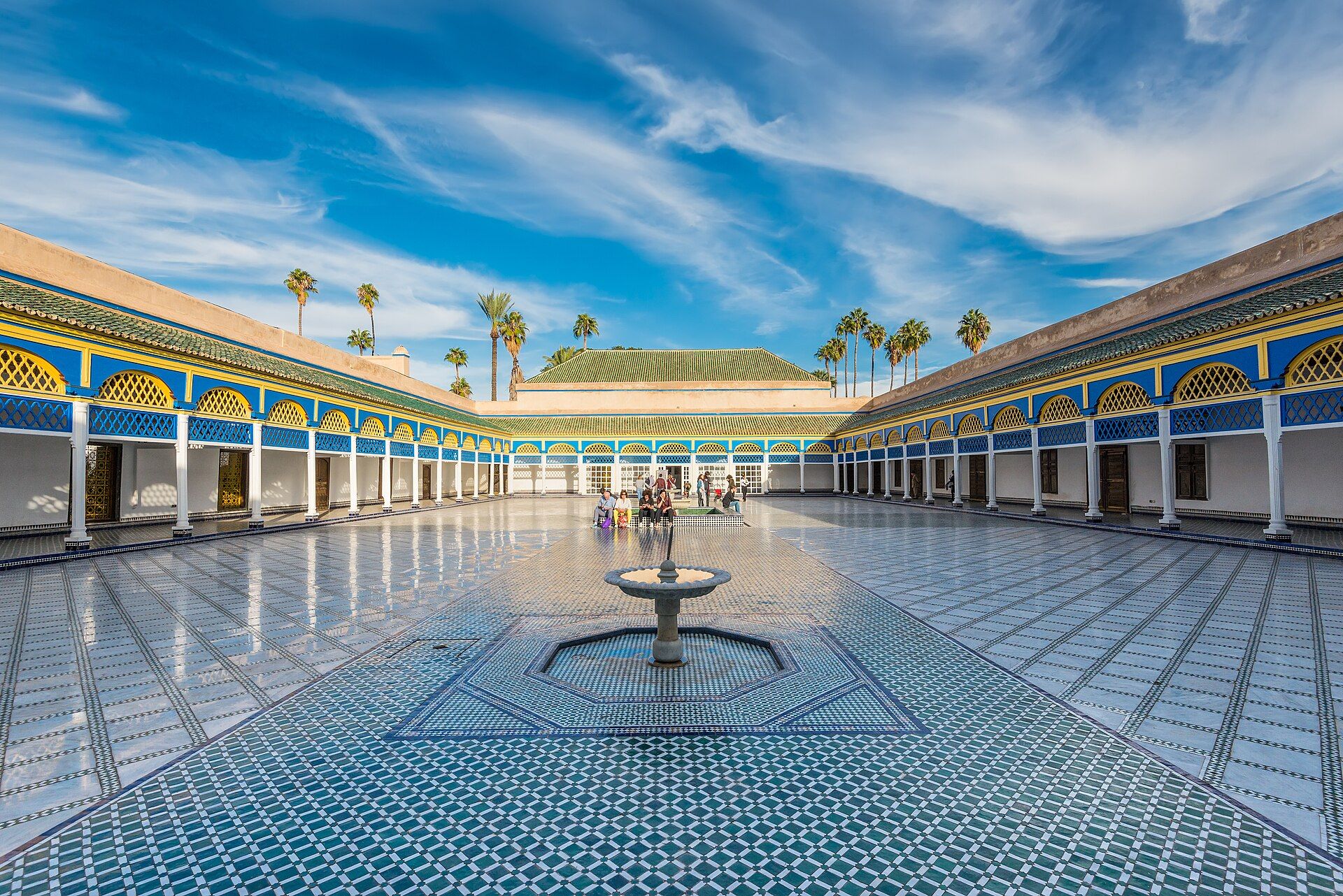 Courtyard of the Bahia Palace in Marrakesh with zellige tiles and palm trees